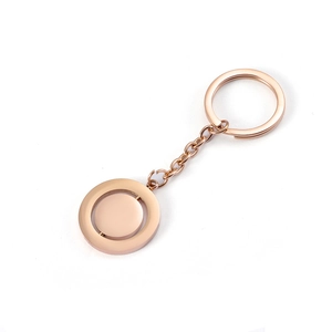 Detail of rose gold spinning disk pendant keychain with polished stainless steel finish
