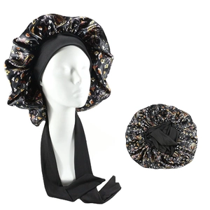 Detailed view of floral satin hair bonnet with adjustable wide elastic straps and long ties