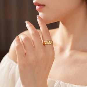 18k gold plated open ring with interlaced hearts and pavé set crystals on model