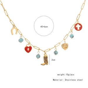 Detail of stainless steel necklace with turquoise beads and golden western boot charm