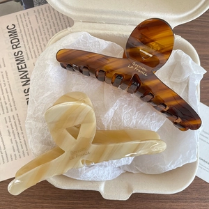 French retro acetate hair claws in tortoise and cream marble finish with gold logo