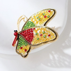 Luxury butterfly brooch with colorful crystals and gold hollow wings on white surface