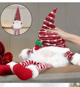 Detail of red and white knitted Nordic Christmas gnome topper with a soft pointed hat