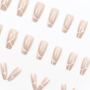 Coffin shaped press-on nails in nude with white abstract marble line patterns