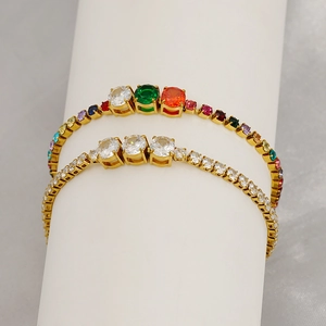 Detailed close-up of rainbow and white zircon tennis bracelets in gold-plated settings