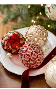 Close-up of 8cm vintage glass Christmas balls with glitter patterns on a ceramic plate