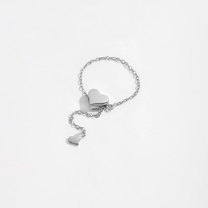Macro detail of S925 sterling silver chain ring featuring dual heart shaped charms