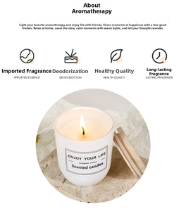 Detailed close-up of a soy wax candle in glass jar with wooden lid on stone base