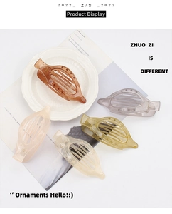 Close-up of leaf-shaped hair clips in amber, pink and green translucent resin