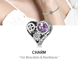 Macro detail of mechanical heart charm with purple gemstone and silver gear accents