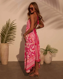 Detail view of a floral halter backless maxi dress with a flowing irregular hemline