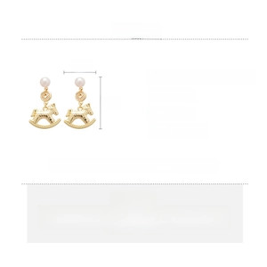 Detail view of golden rocking horse earrings with pearls and zircon measurements