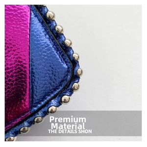 Detail of color-block faux leather texture with silver studs on a stylish crossbody bag