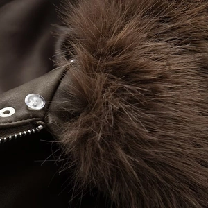 Detail of dark brown PU jacket featuring plush faux fur collar and metal zipper closure