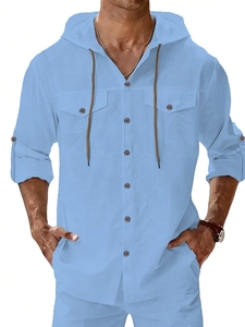 Detail of light blue linen shirt featuring a drawstring hood and chest pockets texture