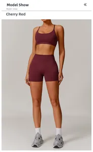 Detail of seamless cherry red sports set with high-waist shorts and U-neck tank top