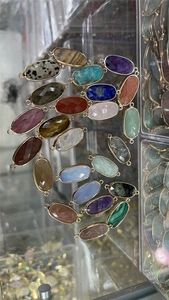Detailed macro view of multifaceted oval crystal connectors in various vibrant colors