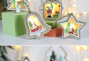Close-up of glowing wooden Christmas ornaments with LED lights and festive illustrations