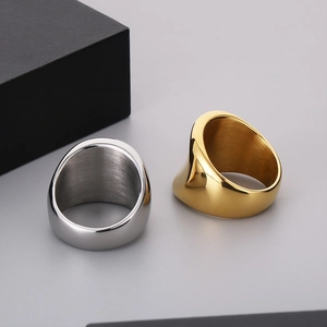 Detailed view of wide 18k gold and silver stainless steel rings with brushed inner finish