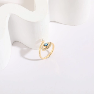 Detail of 14K gold plated evil eye ring with blue enamel, zircon, and small pearl