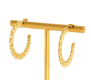 Macro shot of 18K gold plated hoop earrings with vintage twisted rope pattern texture