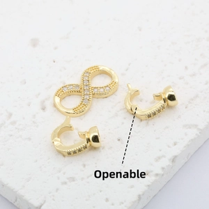 Close-up of 18K gold plated infinity jewelry clasp with micro-set stones and openable hooks
