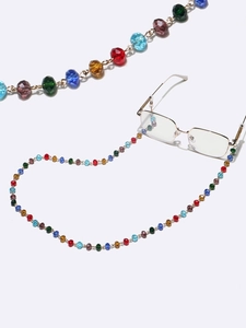 Close-up of 10mm colorful crystal bead chain with gold connectors on gold glasses