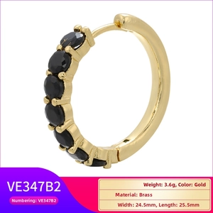 Detailed view of gold plated brass hoop earrings inlaid with five round black zircons