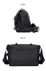 Detail view of black functional messenger bag showing side buckles and hidden back zip