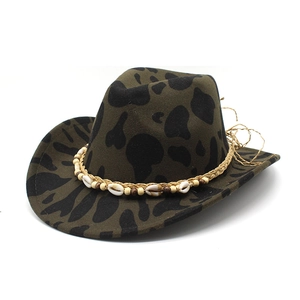 Close-up of felt fedora with cow print, ethnic band, seashells and wooden beads