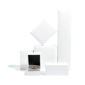 Minimalist white textured jewelry boxes for rings and necklaces on white background