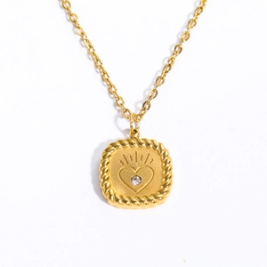 Golden tarot style necklace with heart pendant and rope textured edge on white background