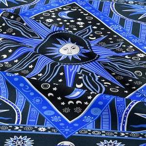 Detailed view of bohemian sun and moon tapestry with midnight blue celestial patterns