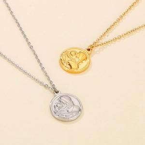 Detail of gold and silver necklaces featuring embossed Virgin Mary coin pendants and chains