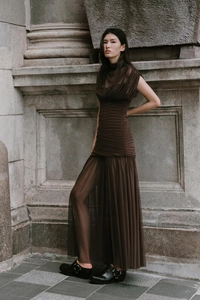 Detail of sheer pleated mesh hem and ruched body on a brown slim fit maxi dress