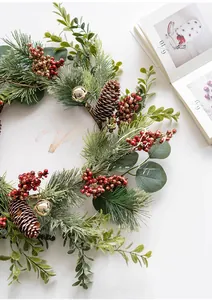 Detailed Christmas wreath with berries, pine cones and bells on white background