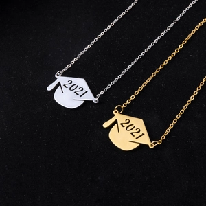 Macro shot of 2021 doctoral graduation cap necklaces in gold and silver steel finish