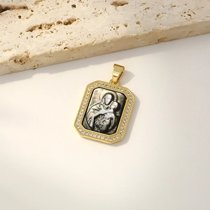 Gold-plated rectangular Mother of Pearl Virgin Mary pendant necklace on a beige stone