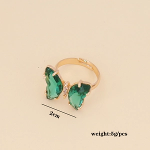 Detail view of gold adjustable ring featuring green butterfly zircons and 5g weight data