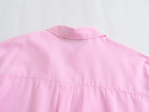 Close-up of the collar and shoulder seams of this pink long-sleeved cotton oxford shirt