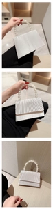 Detailed views of a white pleated satin evening bag with a premium pearl bead handle