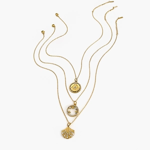 Three-layer gold necklace with engraved disc, shell pendant and crystal star accents
