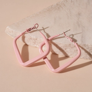 Pink geometric square earrings displayed on natural stone with a matte finish