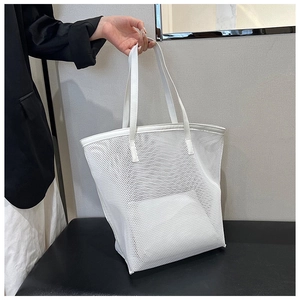 Detail of white mesh tote bag with matching inner pouch for summer beach use