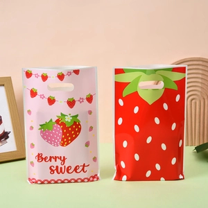 Pink and red strawberry gift bags with die-cut handles and sweet berry prints