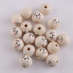 Flat lay of 20mm natural wood beads with cute animal face patterns and center holes