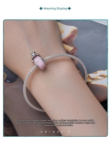 Close-up of S925 sterling silver mesh bracelet with pink cat charm and heart detail
