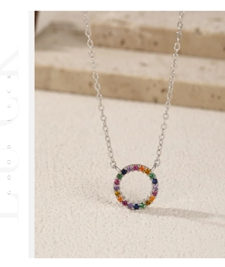 Macro shot of S925 silver necklace with rainbow zircon stones on elegant stone base