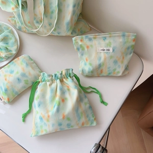 Detail view of mint green watercolor fabric storage set with simple wish brand label