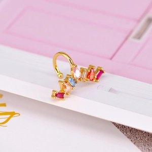Close-up of multicolored zircon ear cuff with gold finish and pear-shaped gemstones